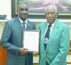 Rivers accepts an award from Kenneth Cutts on behalf of Congressman Sanford Bishop.