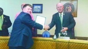 Becky Crissman/ Cordele Dispatch ABOVE: Criisp County Commission Chairman Clark Henderson presents Eli Tinsley with a proclamation for National Tourism week.  